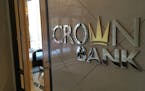 Crown Bank is suing three of its former officials and another bank.