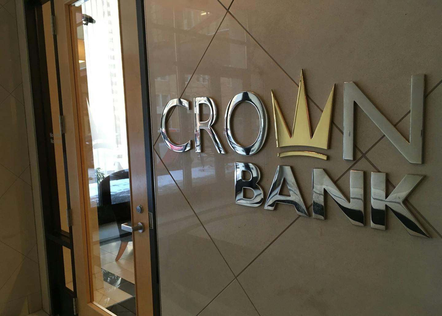 Crown Bank is suing three of its former officials and another bank.