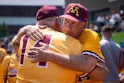 Gophers coach John Anderson hugs his brother Mike at his retirement ceremony last weekend at Siebert Field.
