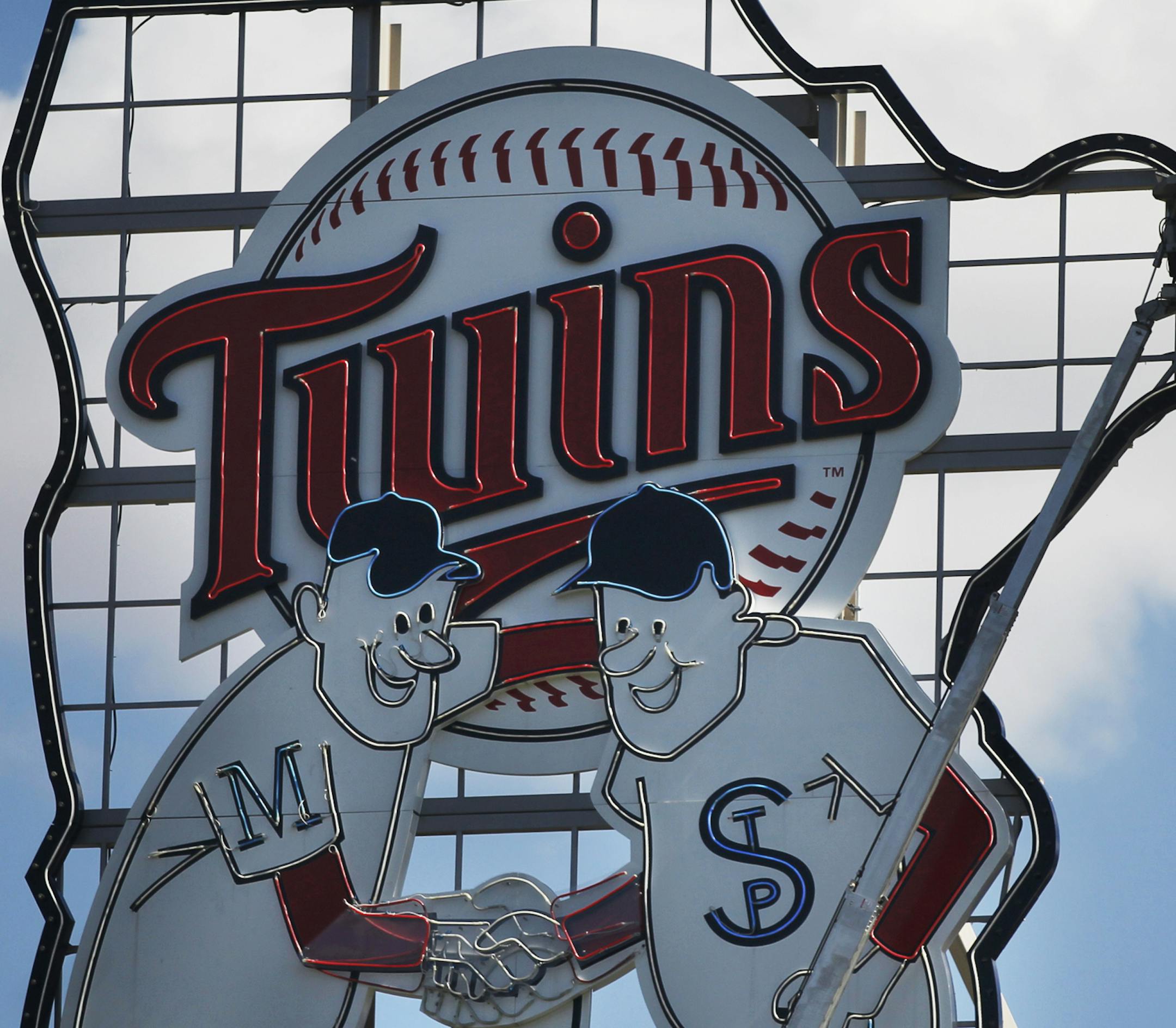 Richard Tsong-Taatarii/rtsong-taatarii@startribune.com Minneapolis, MN;4/6/11;left to right ] At Target Field, a crew checks the lights on the Minnie and Paul sign in preparation for the home opener on Friday against Oakland.