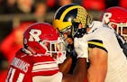FILE -- Players square off during a college football game between Rutgers and Michigan in Piscataway Township, N.J., Nov. 10, 2018. After a season of 