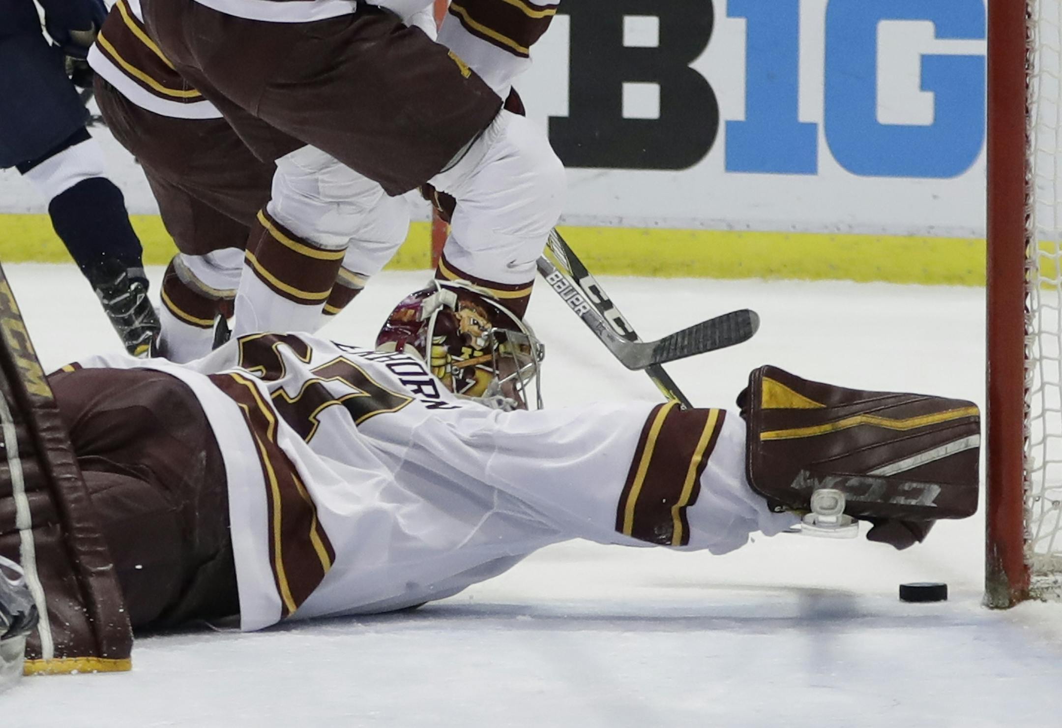 Minnesota goalie Eric Schierhorn reaches to stop the puck during the first period of an NCAA college hockey semifinal match against Penn State in the Big Ten Tournament, Friday, March 17, 2017, in Detroit. (AP Photo/Carlos Osorio)