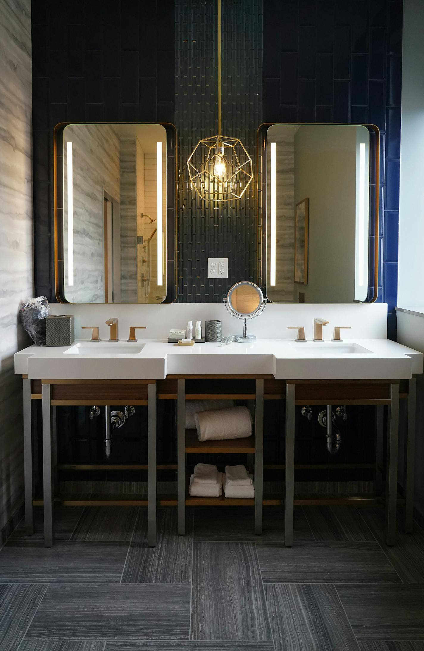 Natural light shines in through a window in a guest room bath.