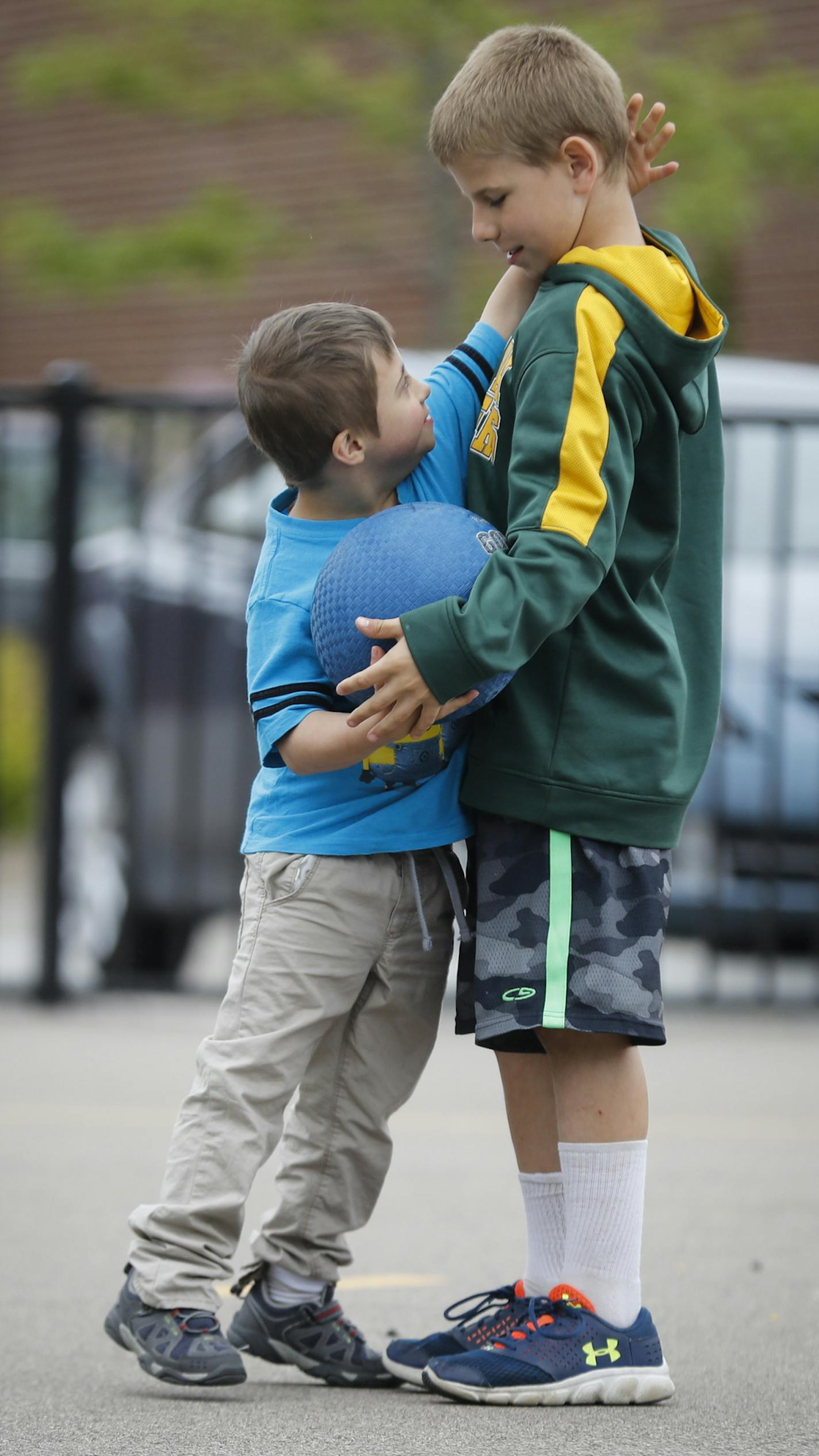 Quentin Geisel hugged Will Ackerman as he brought him the ball to pitch during a kickball game during recess at Lake Harriet Community School lower campus on Tuesday, May 30, 2017. ] RENEE JONES SCHNEIDER &#x2022; renee.jones@startribune.com