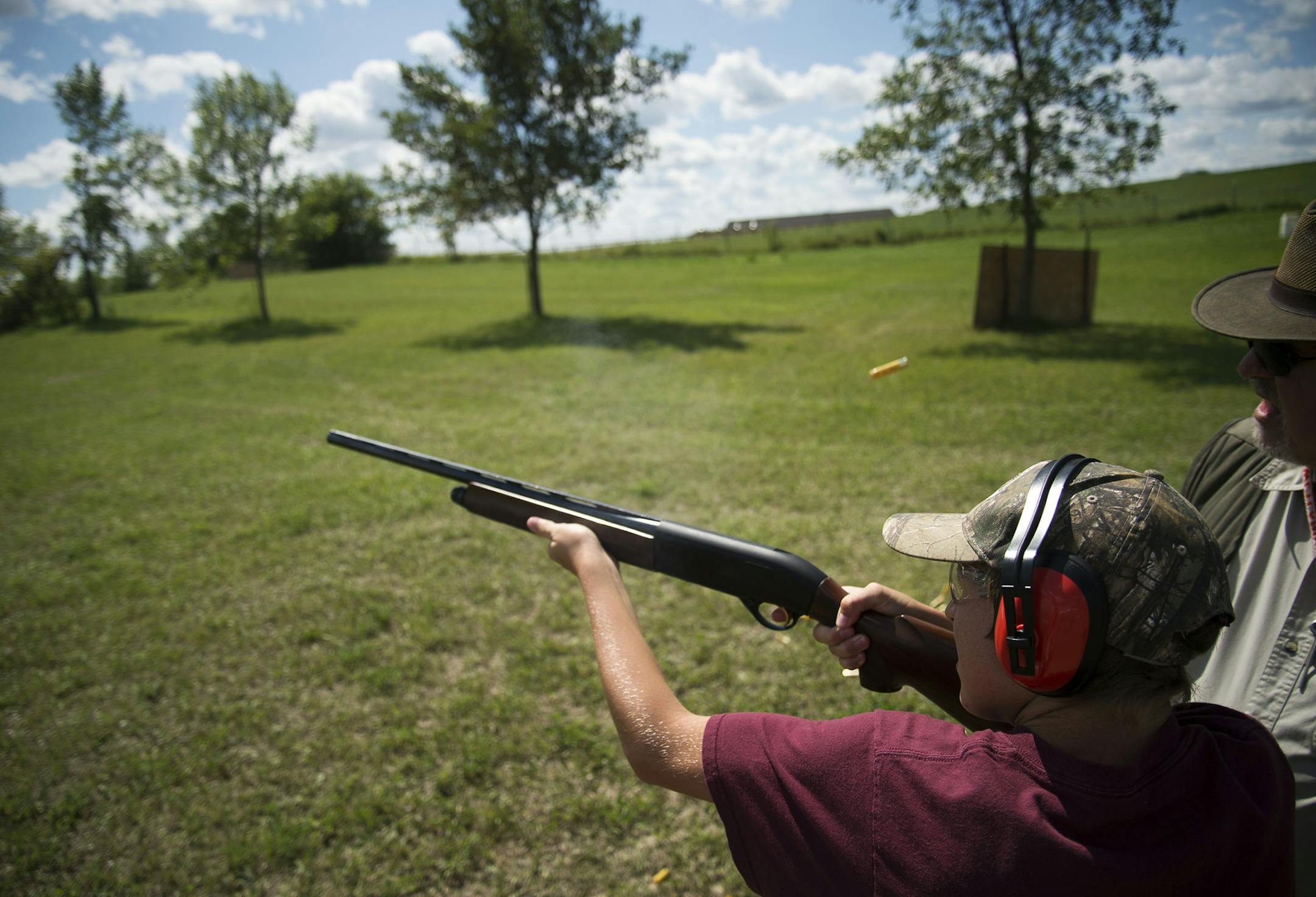 Shooting instructor John Wolf of New Prague stood alongside 13-year-old Cody Stanisich of Eveleth at the Prairie Wetlands Learning Center in Fergus Falls.