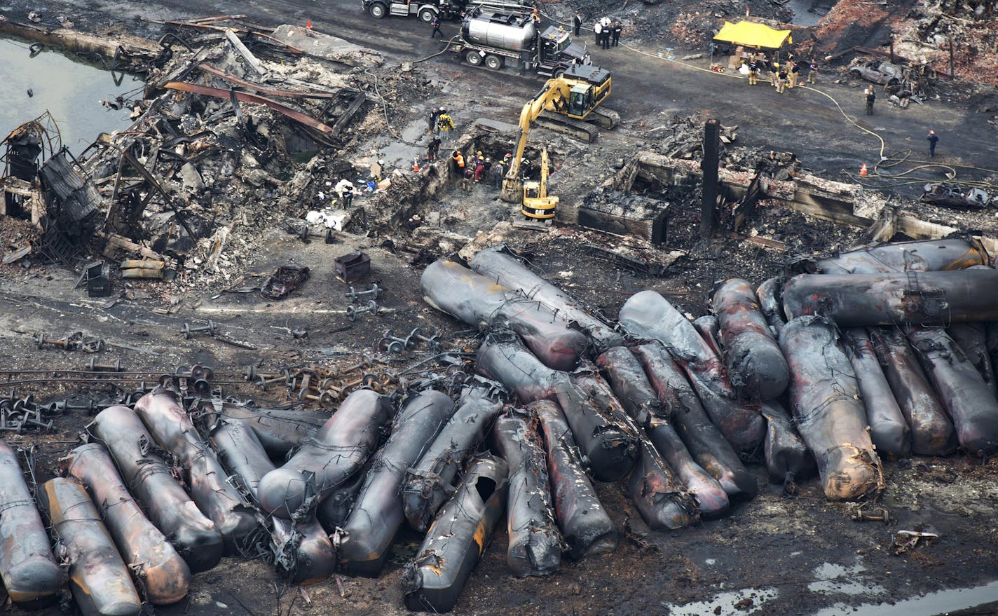 July 9, 2013: Workers comb through debris after a train derailed three days earlier causing explosions of railway cars carrying crude oil in Lac-Megantic, Quebec.