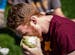 Ethan Logeman digs into a head of lettuce Sunday on the University of Minnesota campus. The University of Minnesota's Lettuce Club returned after a br