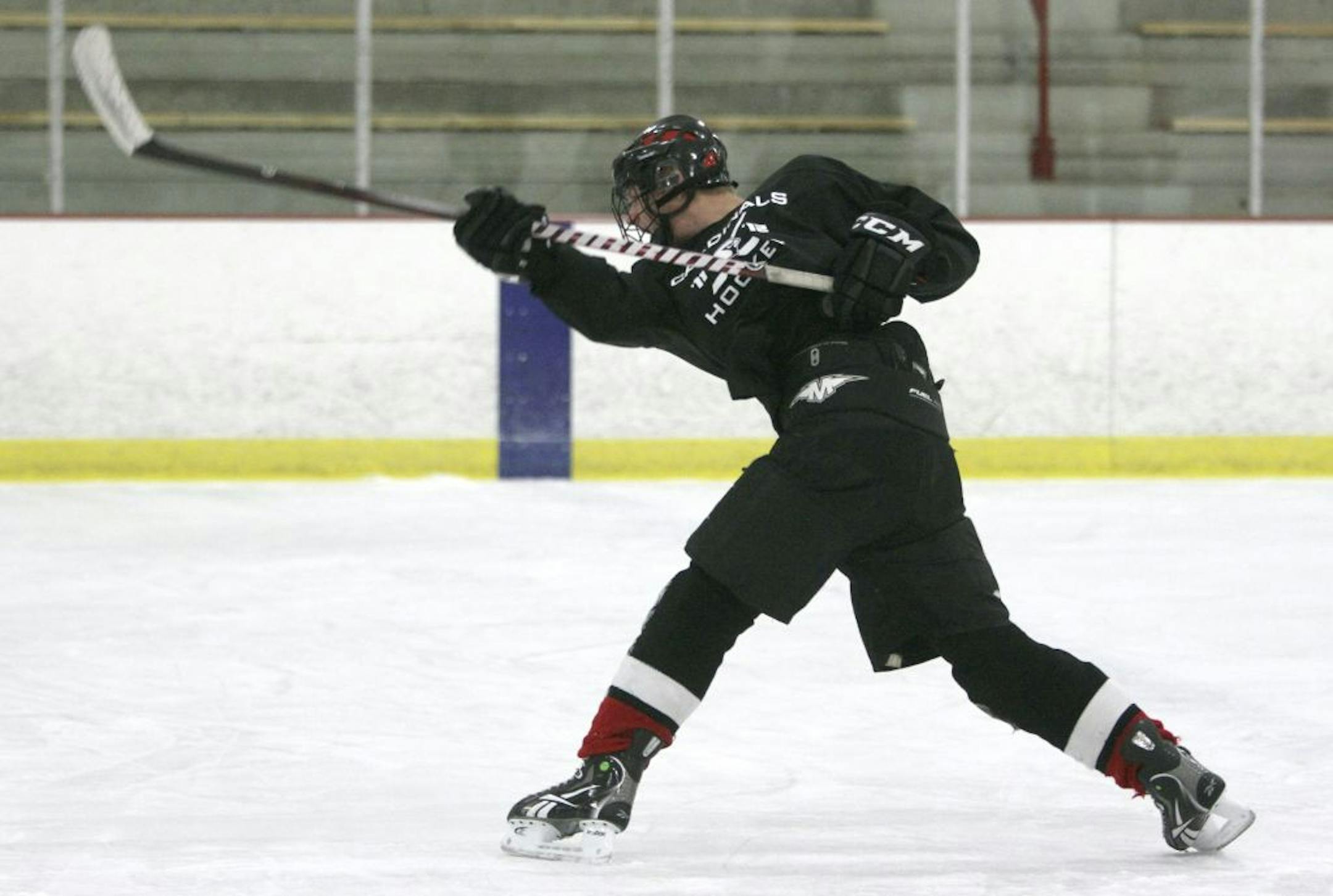 Logan Shore, a junior defenseman for Coon Rapids high school, worked on his slap shot during practice at Schwan Super Rink in Blaine , Min., Wednesday, December 7, 2011.