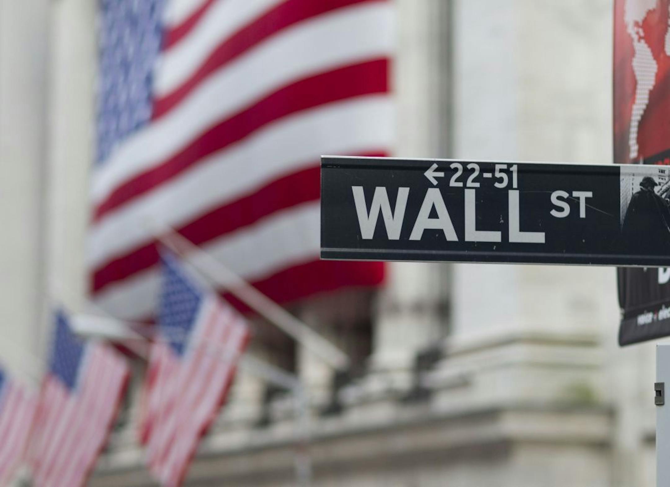 A Wall Street sign hangs near the New York Stock Exchange.