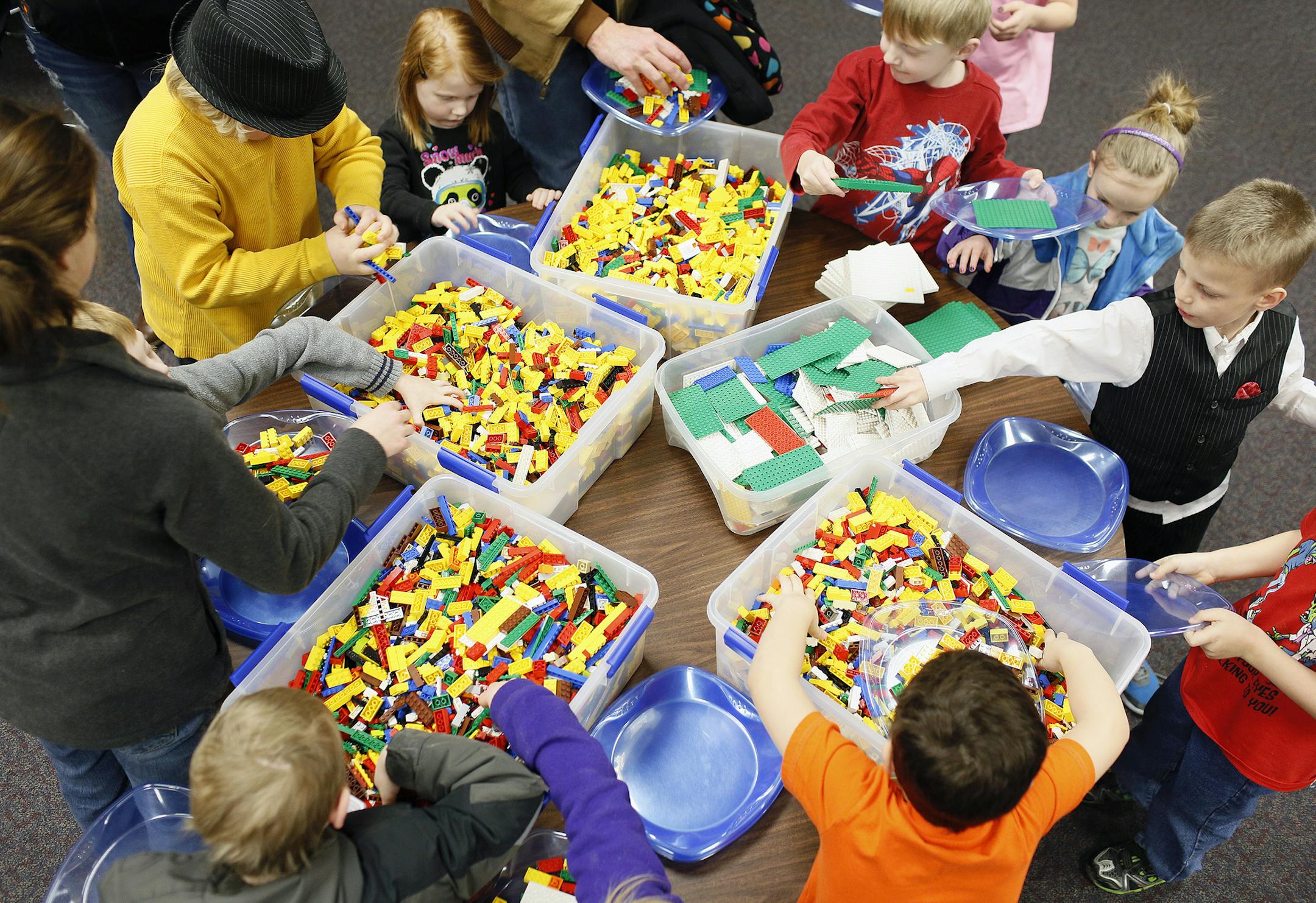 Kids an adults pick out legos to build something with a space theme at the Waterloo Public Library's Lego Lab, Sunday, March 1, 2015, in Waterloo, Iowa. (AP Photo/The Waterloo Courier, Matthew Putney)