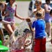 Kids play in the new splash pad at Cliff Fen Park in Burnsville, MN. Water from the park is not reused but drains into the nearby fen. Water flows rot