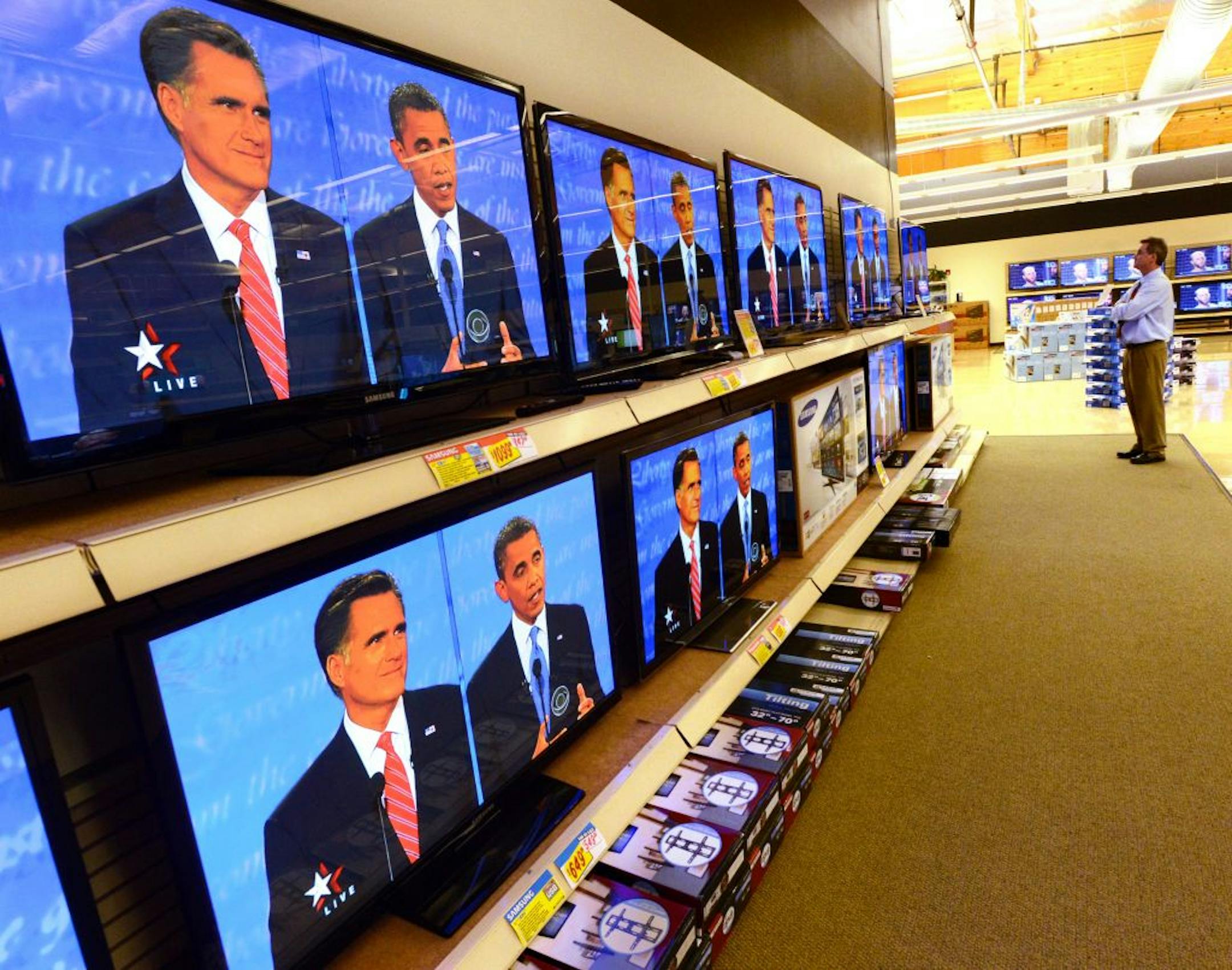 Video Only salesperson Mark MacCoby, of Fremont, California watches the presidential debate on a wall of plasma televisions at the store in Dublin, California, on Wednesday, October 3, 2012. It is the first of three presidential debates and one vice presidential debate held in October.