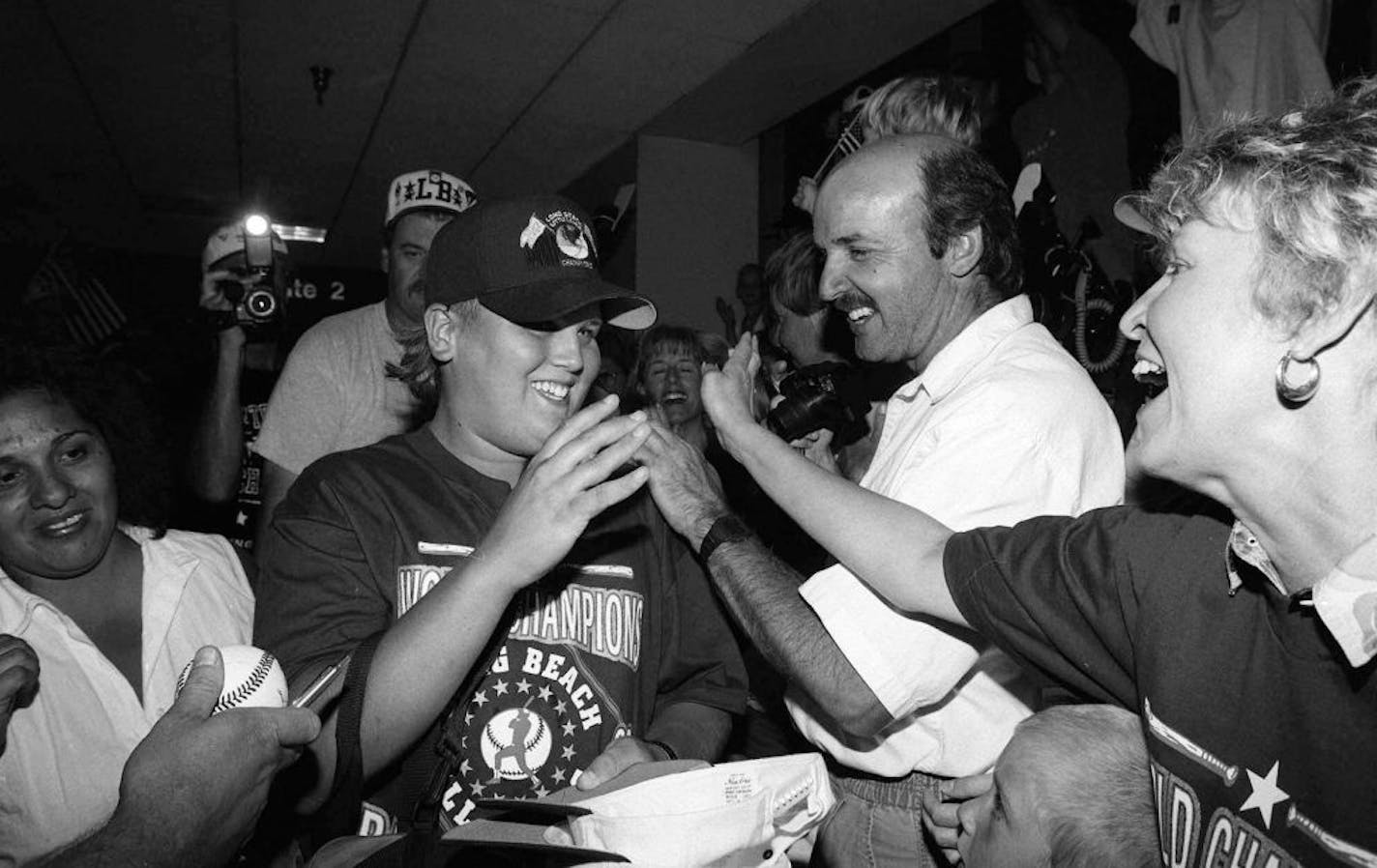 Sean Burroughs, left, pitcher for the Little League World Champion team from Long Beach, Calif., is congratulated as the team arrives at Los Angeles International Airport Aug.29,1993, from Pennsylvania where they scored a 3-2 victory over Panama. The Long Beach team is the first to score back-to-back World Series championships.