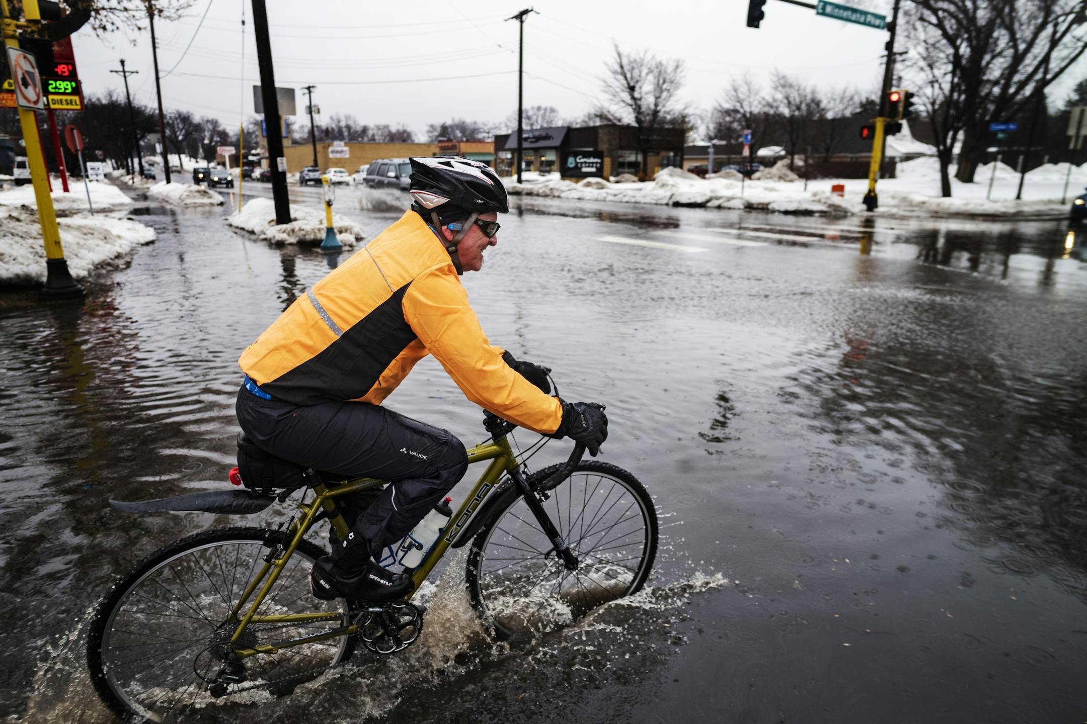 Rain and snowmelt flooded the intersection between CedarAvenue and Minnehaha Parkway in Minneapolis.That did not stop Chris Morris from enjoying his day off.