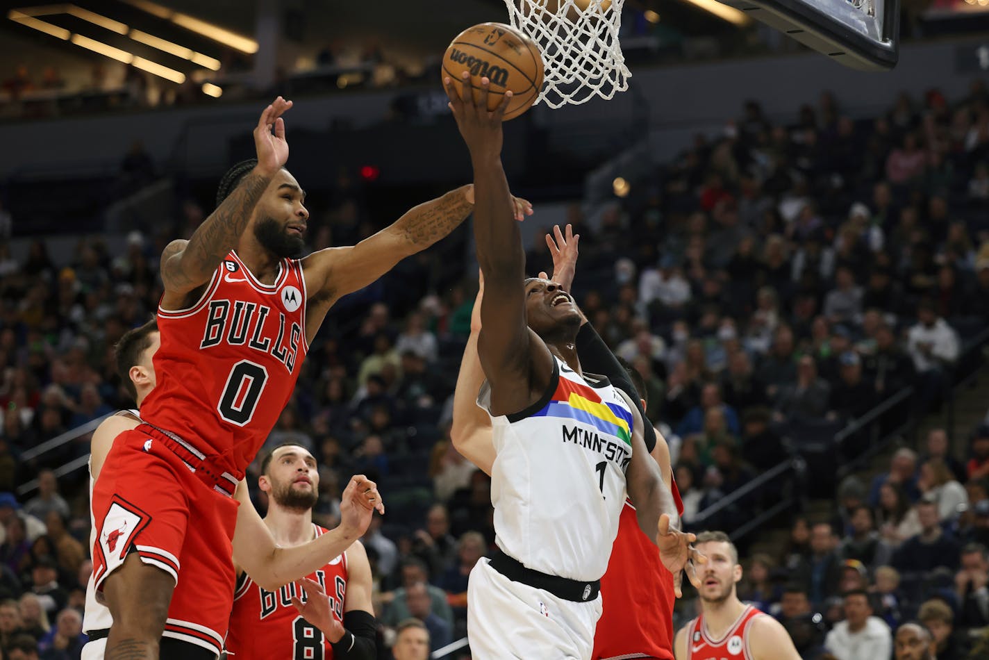 Minnesota Timberwolves guard Anthony Edwards (1) goes up to the basket against Chicago Bulls guard Coby White (0) during the second half of an NBA basketball game, Sunday, Dec. 18, 2022, in Minneapolis. Minnesota won 150-126. (AP Photo/Stacy Bengs)