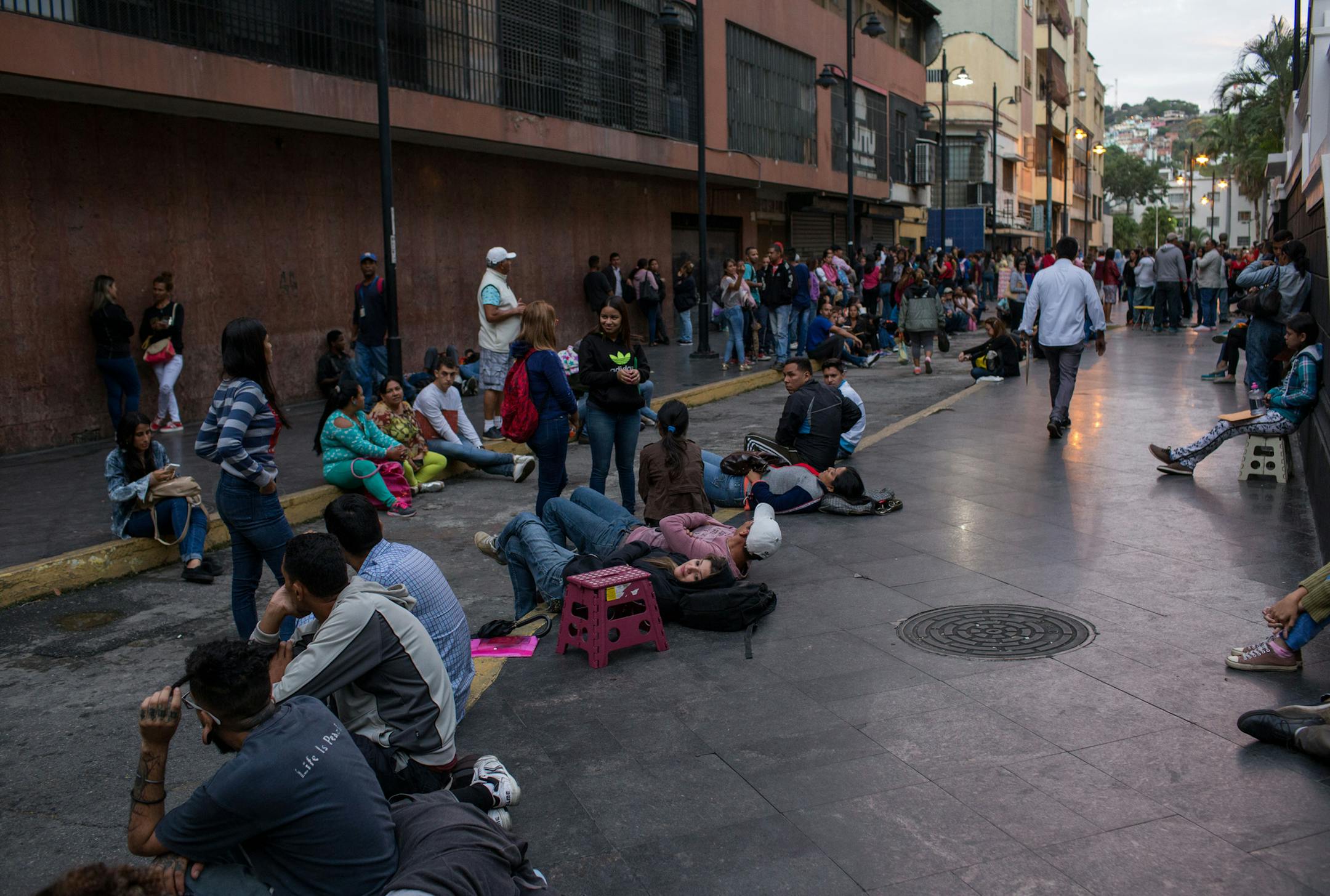 People wait in line to apply for passports in Caracas, Venezuela, on Sept. 18, 2018. MUST CREDIT: Bloomberg photo by Manaure Quintero.