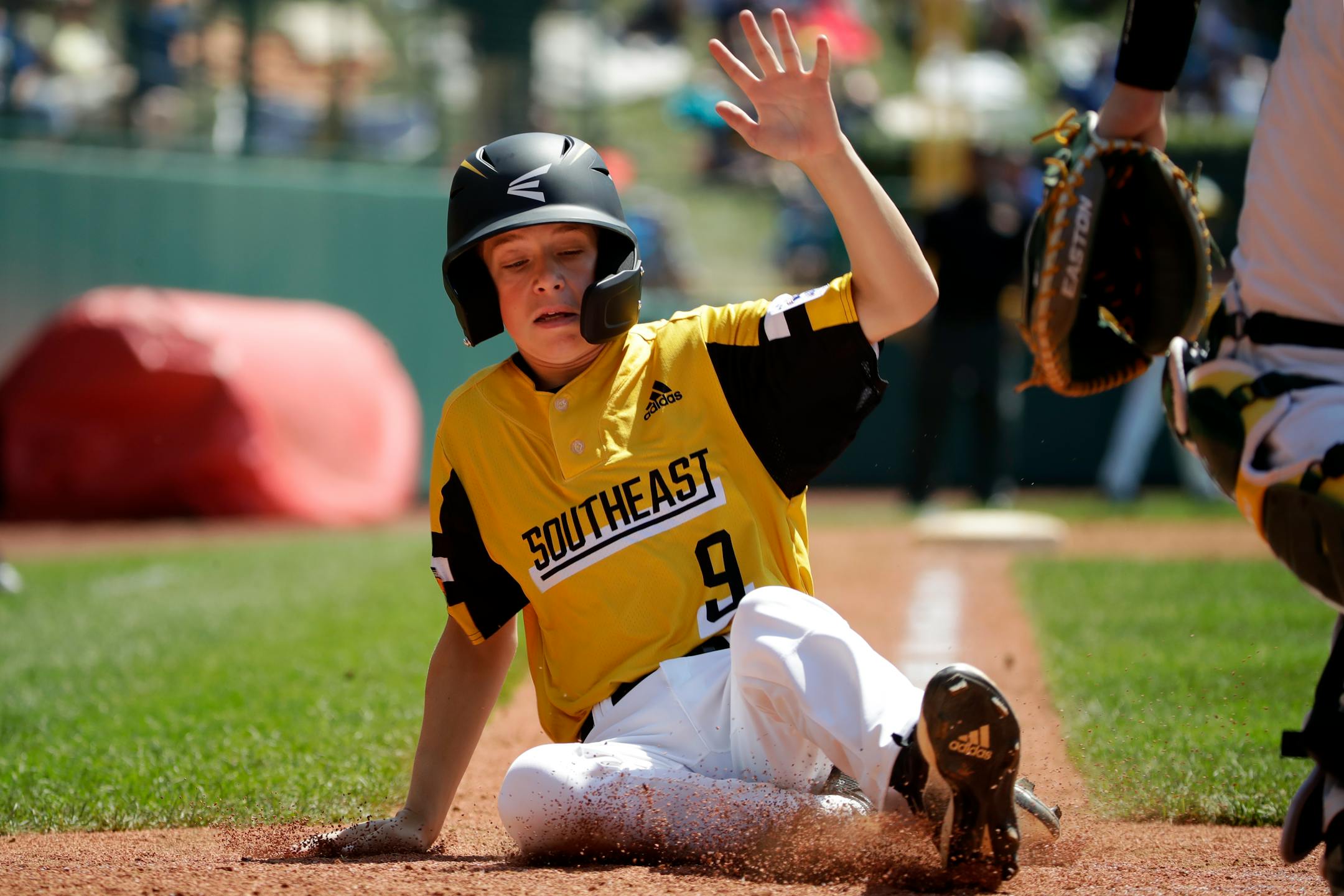 South Riding, Virginia's Colton Hicks scores during the third inning of a baseball game against Coon Rapids, Minnesota at the Little League World Series tournament in South Williamsport, Pa., Sunday, Aug. 18, 2019. Virginia won in four innings, 11-0. (AP Photo/Gene J. Puskar)