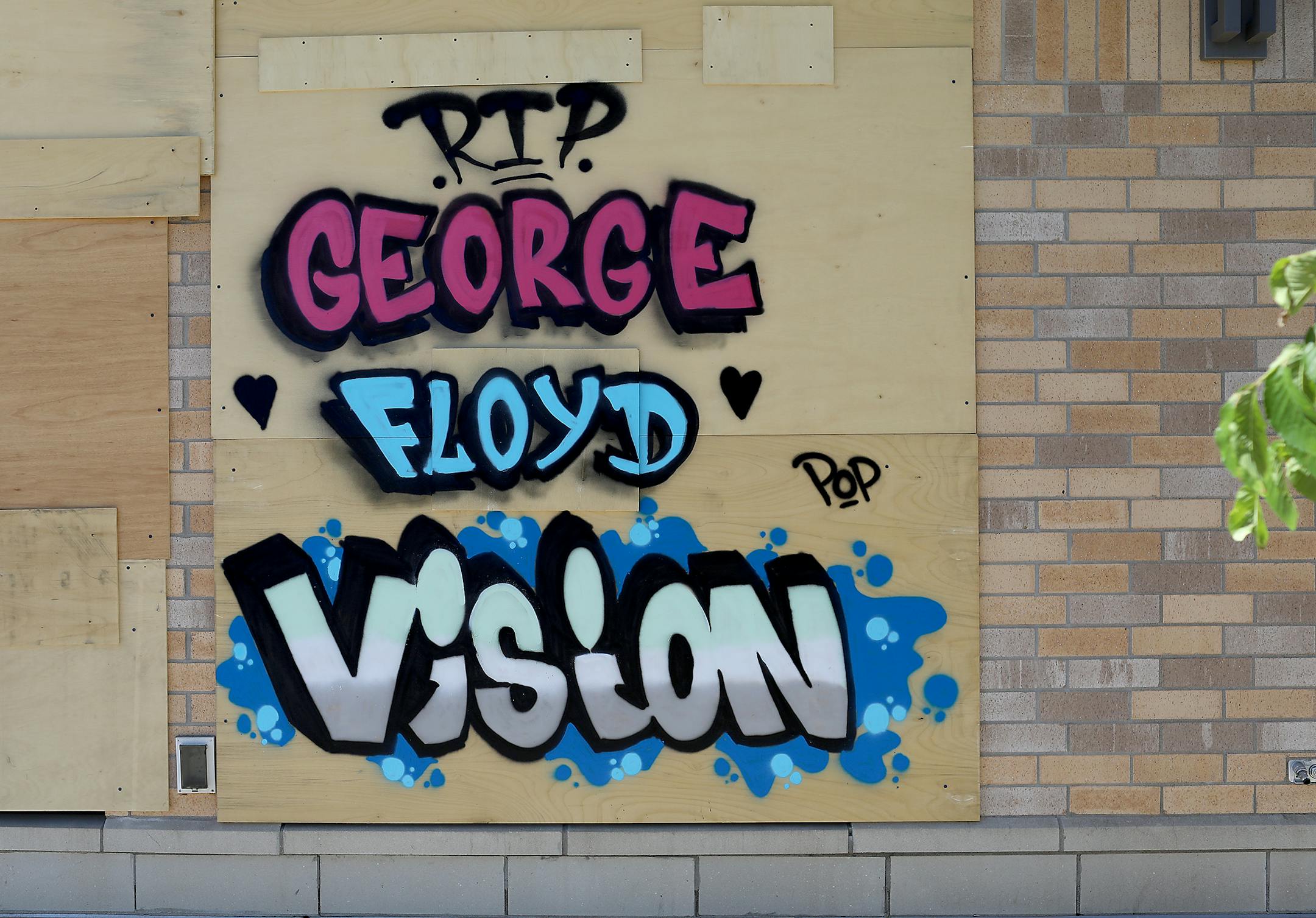 A mural over the windows of Pearl Vision at 1331 University Ave. W. in St. Paul memorializes George Floyd's death and suggests a vision for the future.