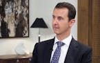 In this photo released by the Syrian official news agency SANA, shows Syrian President Bashar Assad, speaks during an interview with the Spanish news 