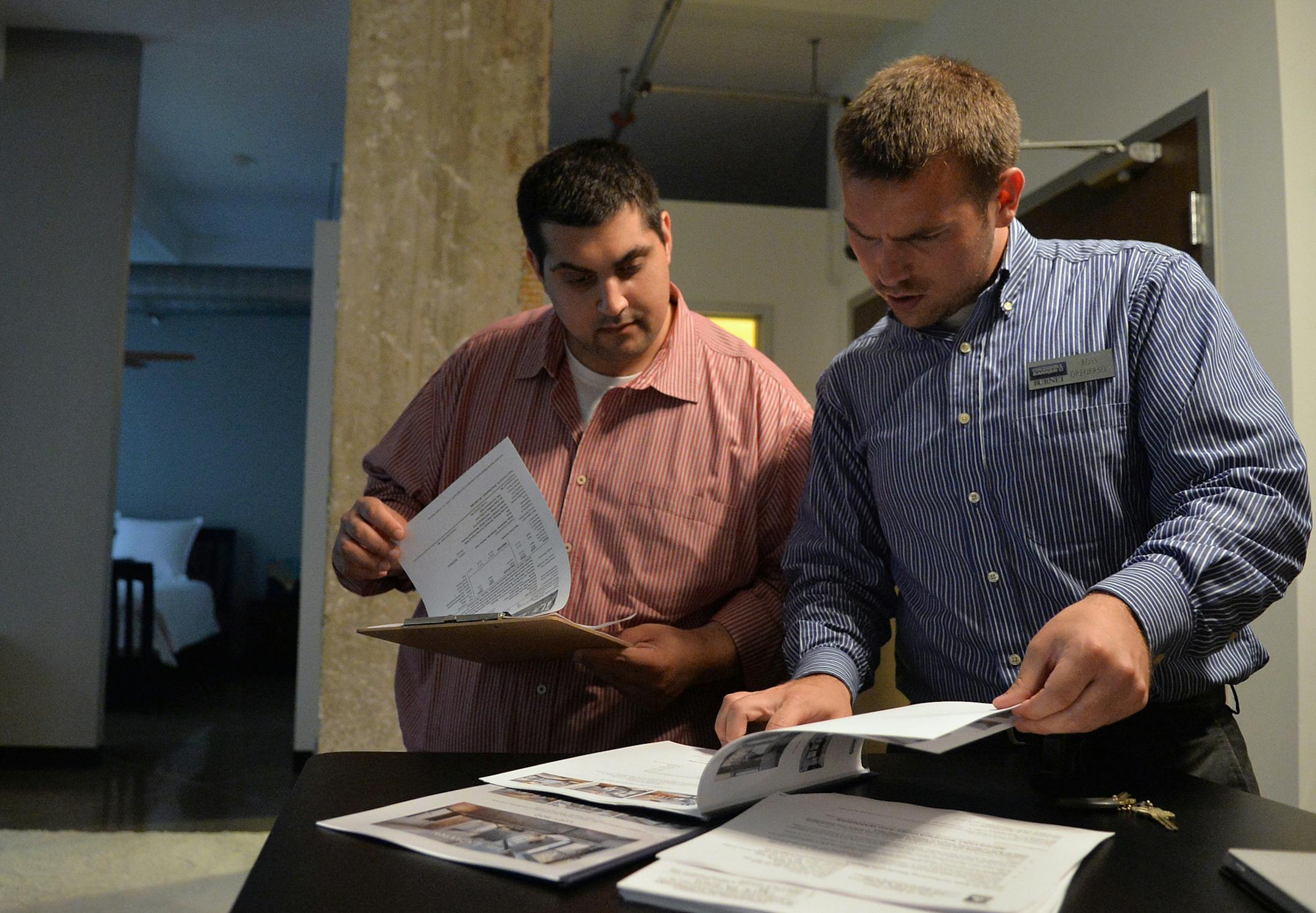 Ross Gregerson, right, of Coldwell Banker Burnet showed millennial home buyer Khalid Khoury a condo in downtown St. Paul.