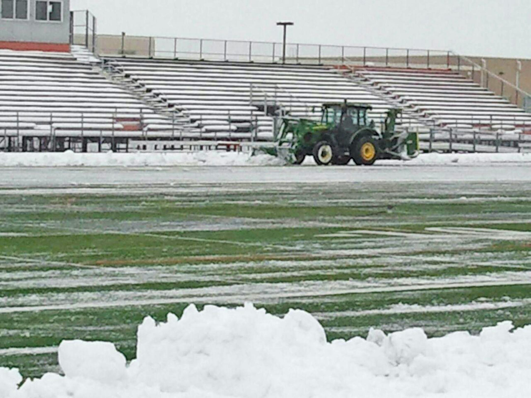 Crews spent Tuesday clearing snow from Osseo High School's football field, where Lakeville North and Totino-Grace are scheduled to play at 7 p.m. Thursday. The game between Class 6A schools is the first of 14 semifinal games that will be played through Saturday at five sites around the metro area as well as at St. Cloud State. Osseo also will host two games on Saturday. credit: Submitted photo 11/11/14