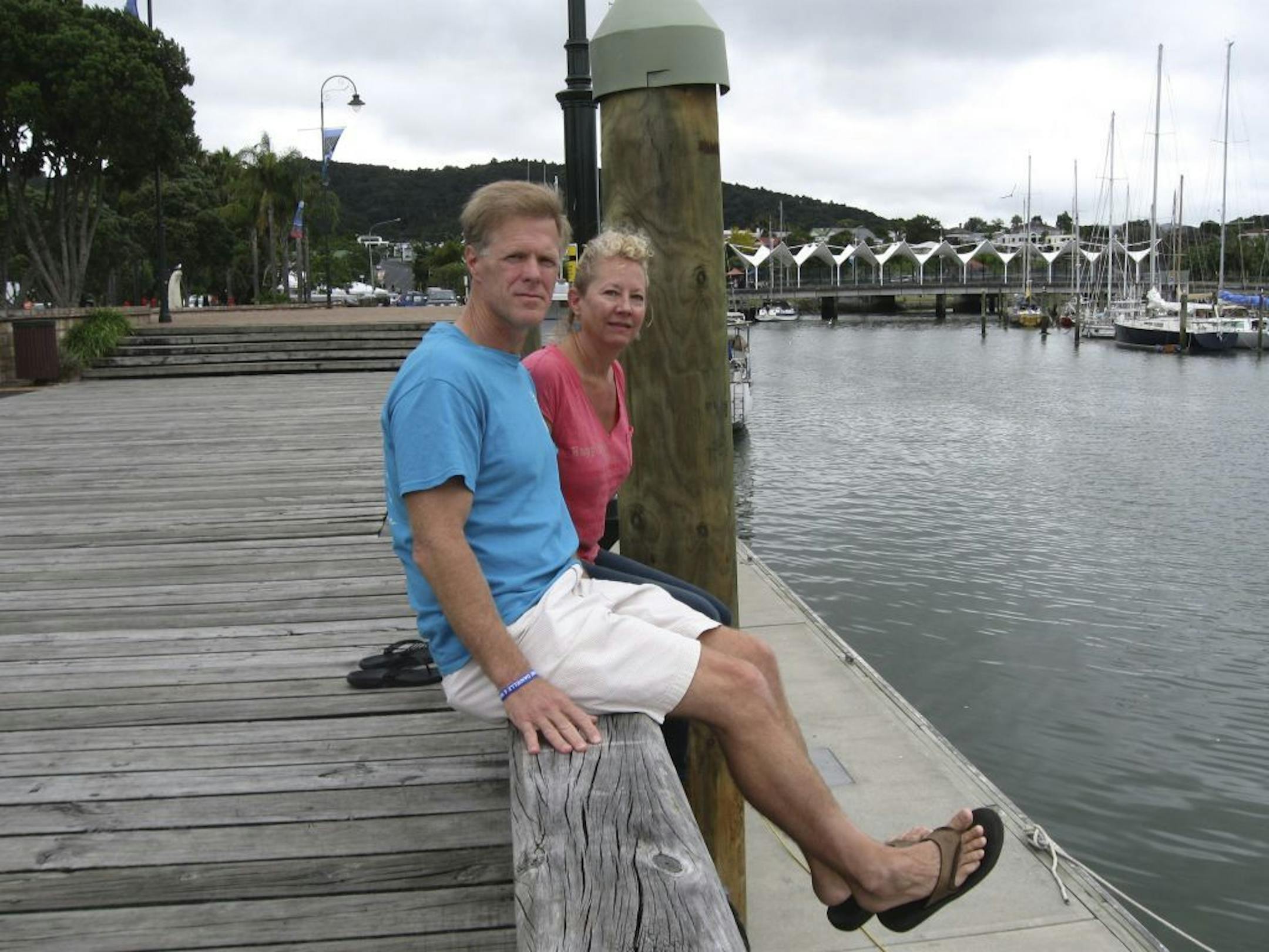 In this undated photo provided by Robin Wright, Ricky Wright and wife Robin Wright sit at a dock in the New Zealand port of Whangarei, where the wooden sailboat Nina was moored in 2013.