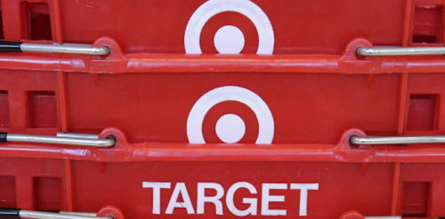 FILE - In this May 20, 2009 file photo, shopping baskets are stacked at a Chicago area Target store. Target Corp. on Tuesday, March 3, 2015 said it plans $2 billion in cost cuts over the next two years through corporate restructuring and other improvements. (AP Photo/Charles Rex Arbogast, File) ORG XMIT: MIN2015031820045771