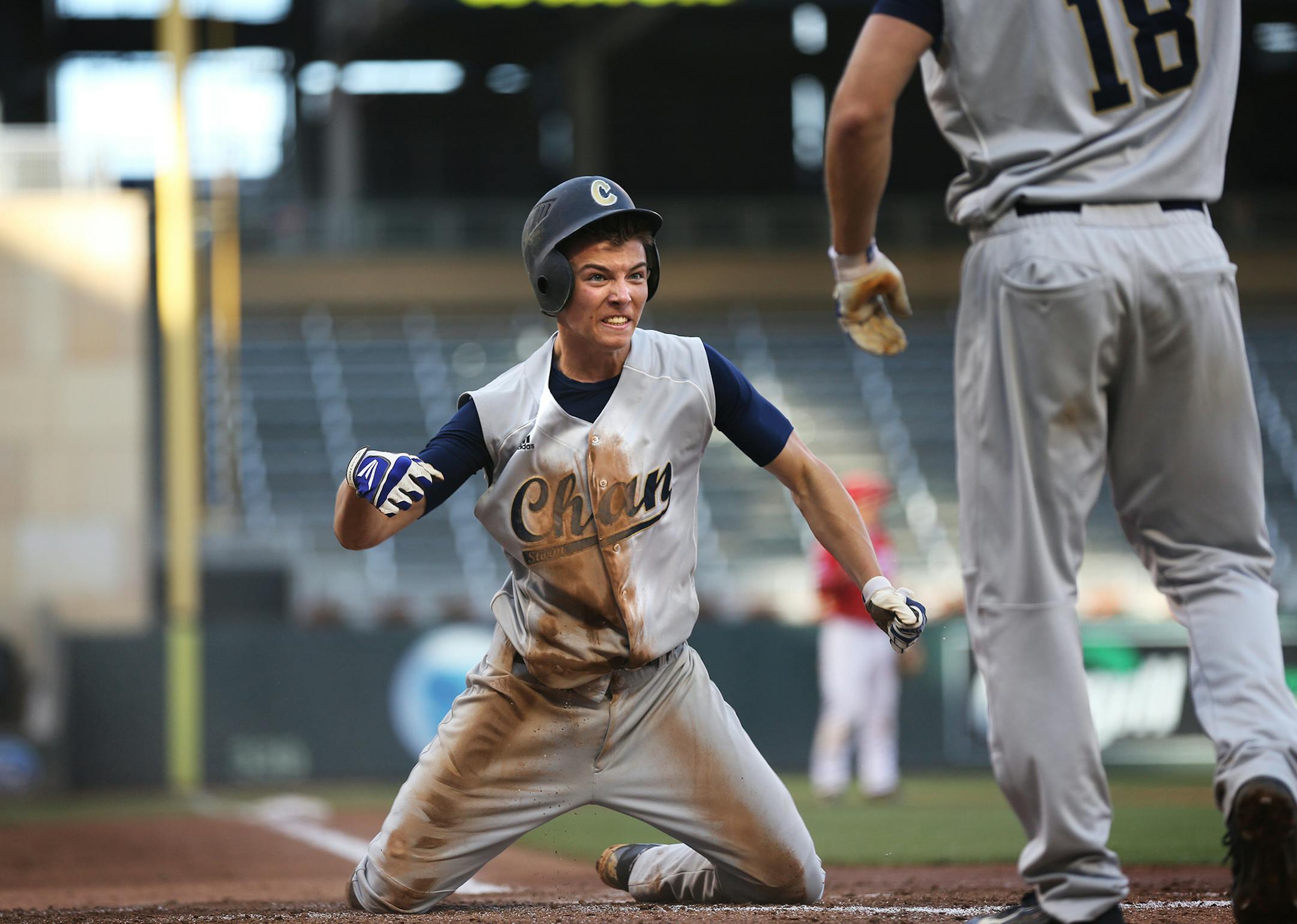 Nick Smith, left, and Jared Davidson celebrate at home plate after scoring two runs in the third inning for Chanhassen their 3A state championship game against Lakeville North at Target Field in Minneapolis on Monday, June 15, 2015. ] LEILA NAVIDI leila.navidi@startribune.com /