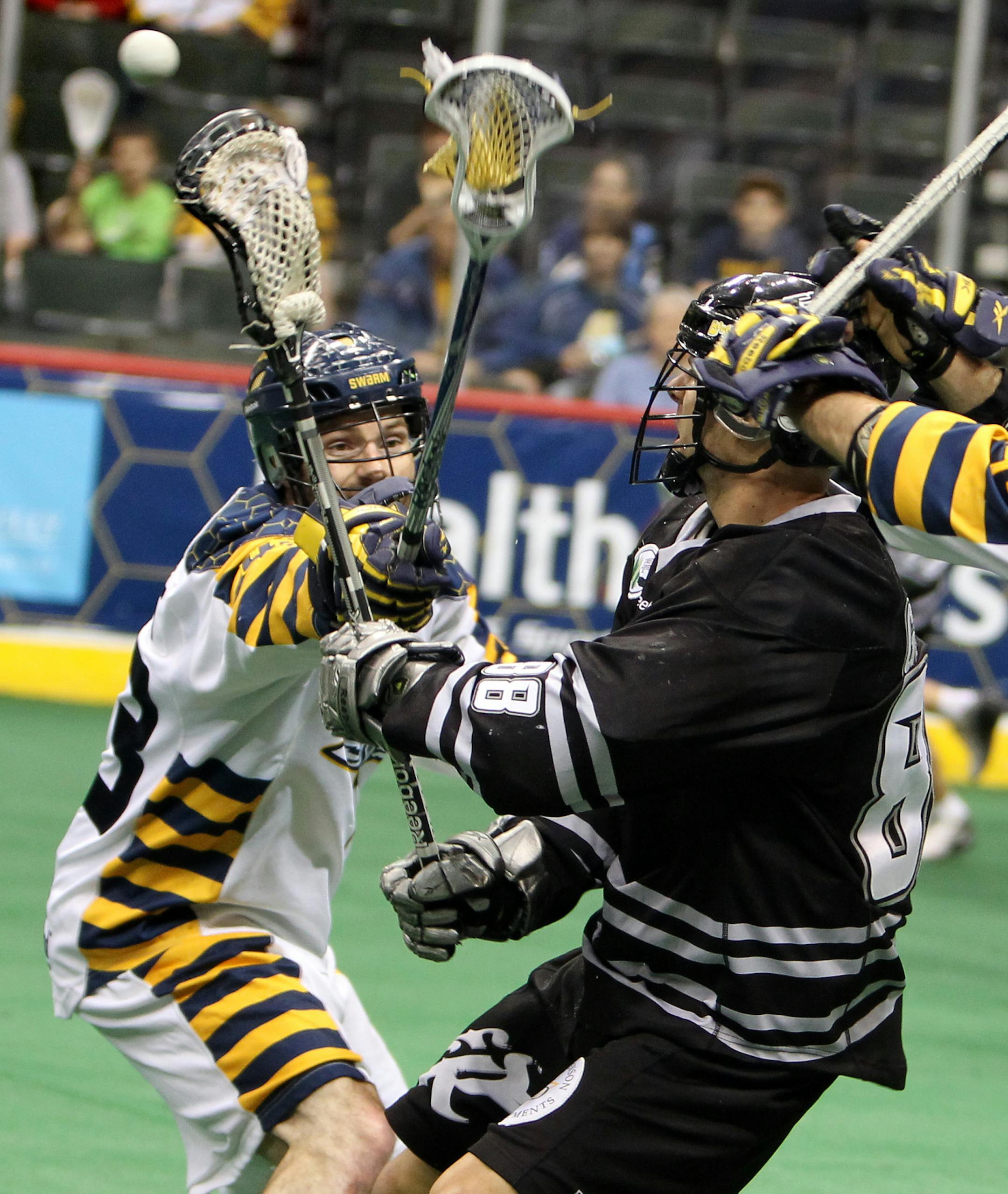 Minnesota's Jeff Gilbert (43), left, lunges for the ball as Edmonton's Zack Greer (88) passes the ball during The Minnesota Swarm's game against Edmonton in the West Division Finals of the National Lacrosse League playoffs at Xcel Energy Center in St. Paul May 12, 2012. (Courtney Perry/Special to the Star Tribune) ORG XMIT: MIN2013101020534599