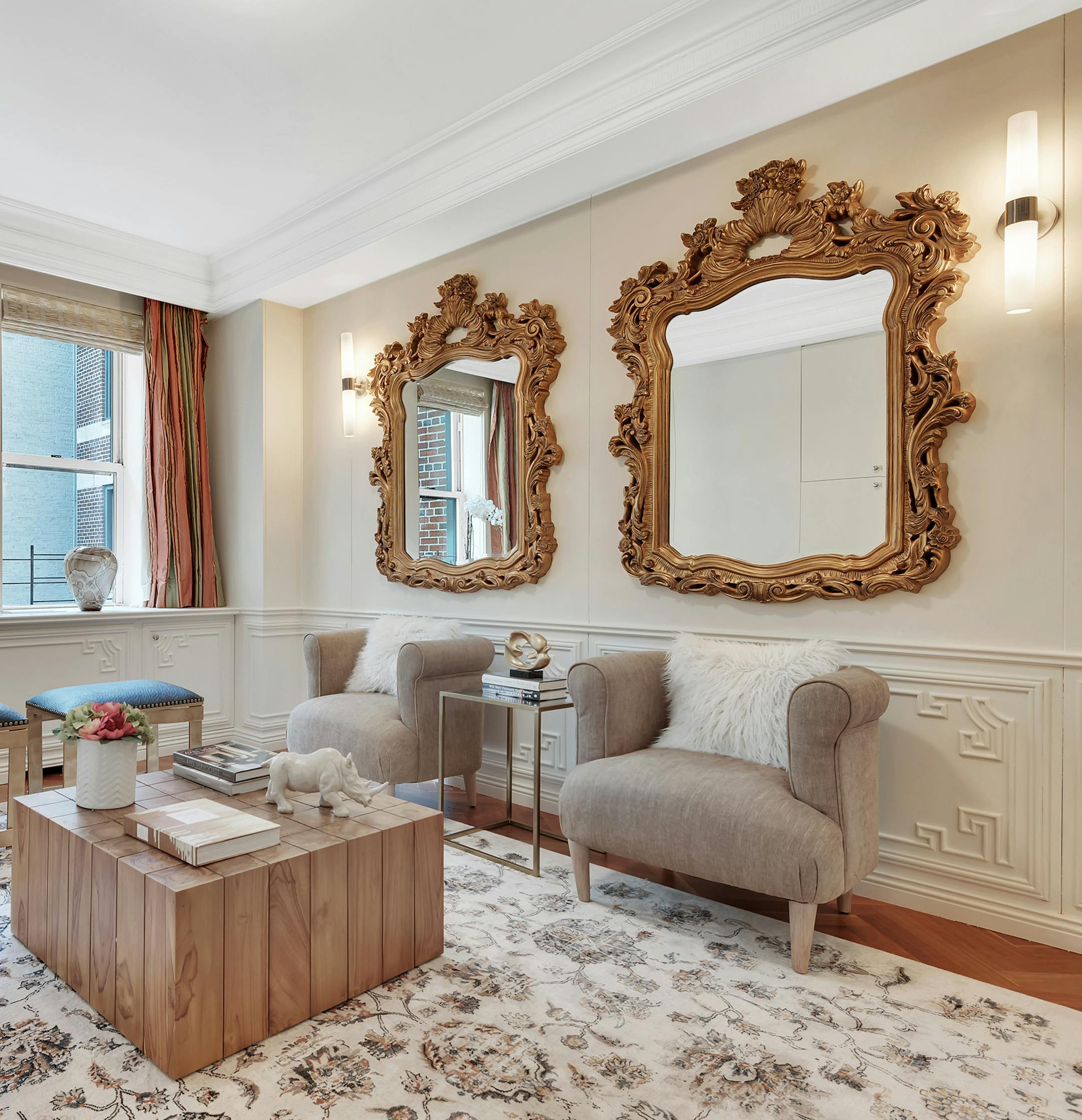 Mirrors are used in lieu of traditional artwork in this den space. (Design Recipes)