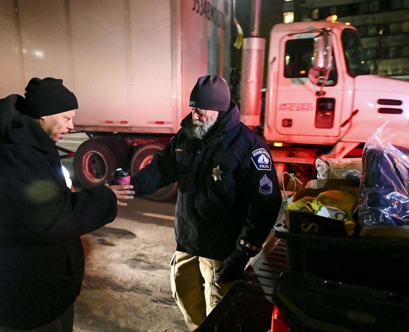 Minneapolis Police Sgt. Grant Snyder handed a cup of hot chocolate to Dawone Boclair outside the public library on Hennepin Avenue in downtown Minneapolis as the temperatures dipped to -20 Tuesday night. ] Aaron Lavinsky &#xa5; aaron.lavinsky@startribune.com Minneapolis Police Sgt. Grant Snyder will be hitting the streets Tuesday and Wednesday night during the height of the big chill - with windchills expected to reach 55 below! - to check on the welfare of homeless people who haven't made it in