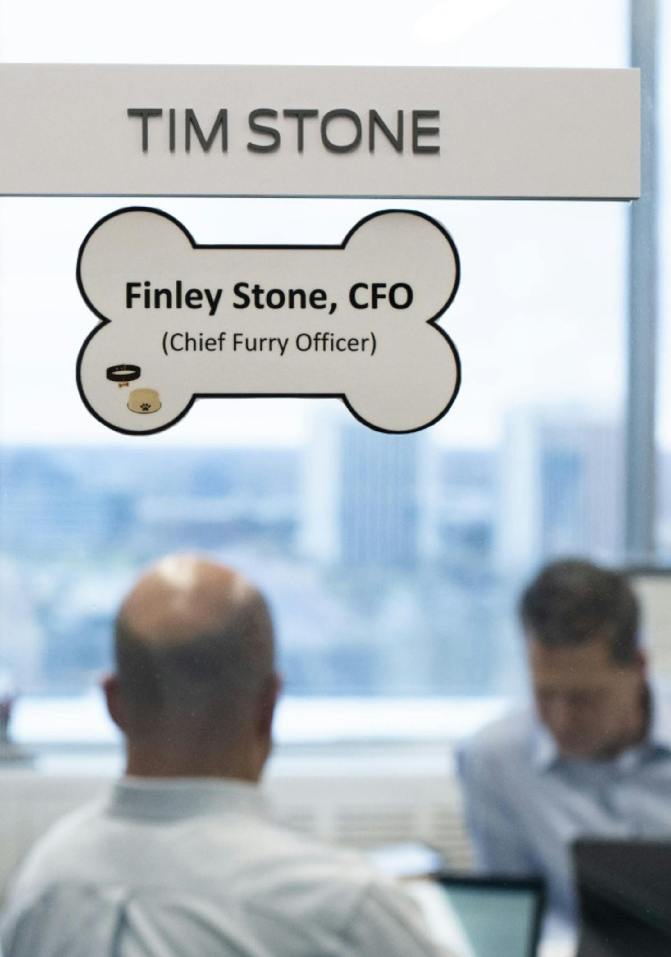 A title for Tim Stone, chief finance officer of Ford Motor Co., and his dog, Finley, hangs outside Stone's office in Dearborn, Mich., on Dec. 5, 2019. MUST CREDIT: Bloomberg photo by Brittany Greeson.