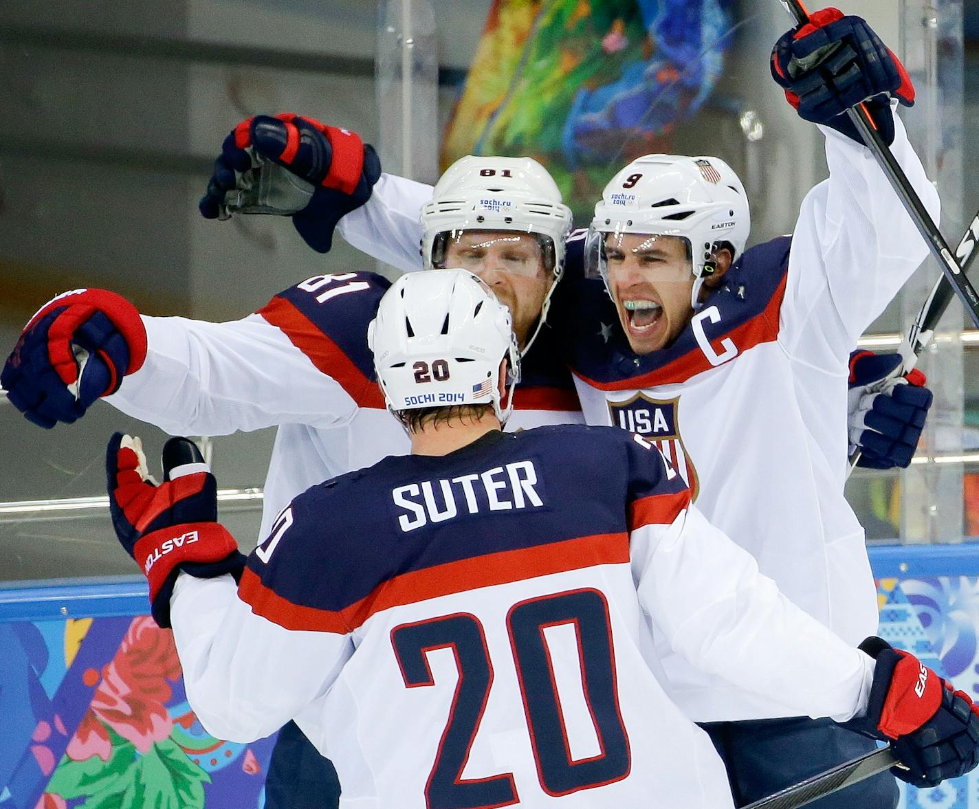 USA forward Zach Parise (9) celebrates his goal against the Czech Republic with teammates Phil Kessel (81) and USA defenseman Ryan Suter during the second period of men's quarterfinal hockey game in Shayba Arena at the 2014 Winter Olympics, Wednesday, Feb. 19, 2014, in Sochi, Russia. (AP Photo/Matt Slocum)