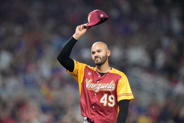 Venezuela pitcher Pablo Lopez tips his hat to the crowd as he is replaced during the fifth inning of a World Baseball Classic game against Puerto Rico