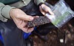 Tony Jones held a piece of his homemade pemmican. He used a current recipe (with venison) for an old-time outdoors staple.