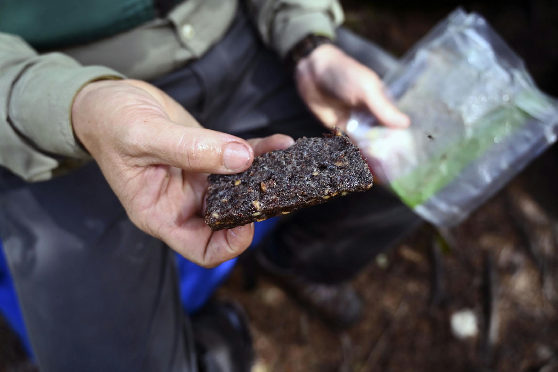 Tony Jones held a piece of his homemade pemmican. He used a current recipe (with venison) for an old-time outdoors staple.