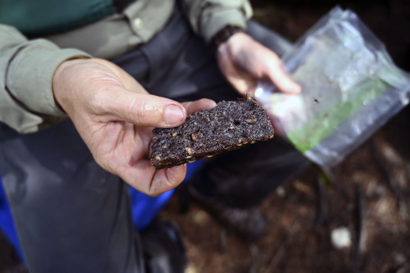 Tony Jones held a piece of his homemade pemmican. He used a current recipe (with venison) for an old-time outdoors staple.