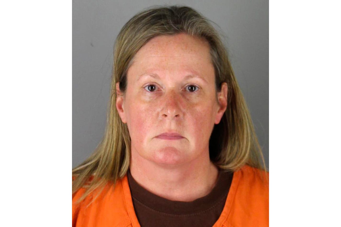 FILE - This undated booking photo released by the Hennepin County, Minn., Sheriff shows Kim Potter, a former Brooklyn Center, Minn., police officer. The service file of Potter, a suburban Minneapolis police officer charged with manslaughter in Daunte Wright's death includes a commendation for safely resolving an incident involving a suicidal man, as well as a handful of reprimands for driving mishaps. The city of Brooklyn Center late Wednesday, May 5, 2021, released more materials from the service file of Potter, the 26-year veteran who shot the Black 20-year-old during a traffic stop April 11, 2021. (Hennepin County Sheriff via AP)