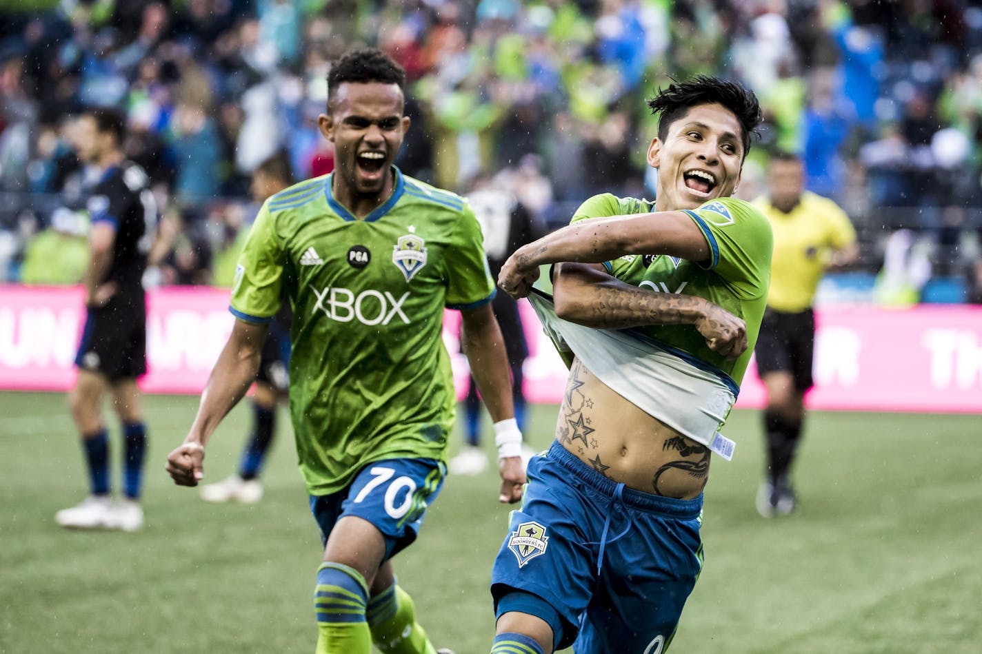 Seattle Sounders forwards Handwalla Bwana, left, and Raul Ruidiaz celebrate Ruidiaz' second goal during an MLS soccer match against the San Jose Earthquakes in Seattle on Oct. 28.