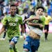 Seattle Sounders forwards Handwalla Bwana, left, and Raul Ruidiaz celebrate Ruidiaz' second goal during an MLS soccer match against the San Jose Earth