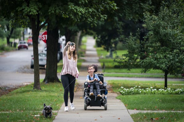 Shane Burcaw and Hannah Aylward filmed an impromptu video while walking their dog Bella in their Minneapolis neighborhood.