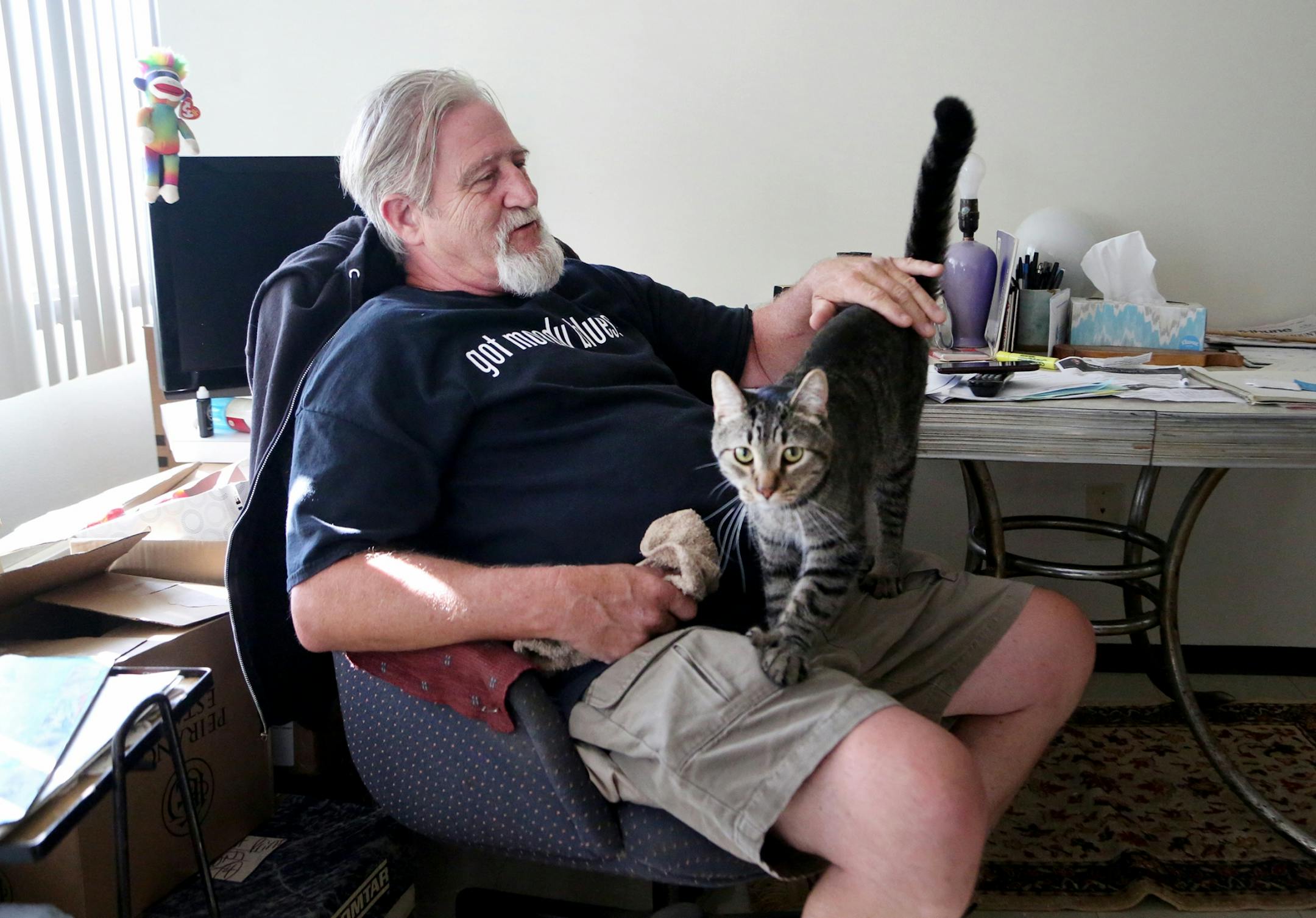 For weeks, Bill McConnell couch surfed and slept in his car after he was forced out of his manufactured home in Lowry Grove, St. Anthony's only mobile home park that closed June 30. Now he got some public help getting an apartment and has moved into his northeast Minneapolis apartment.Here, McConnell was seen with his tabby cat Spotty, 2, whom he was separated from after leaving Lowry Grove until he got his apartment and seen Thursday, Aug. 31, 2017, in Minneapolis, MN.