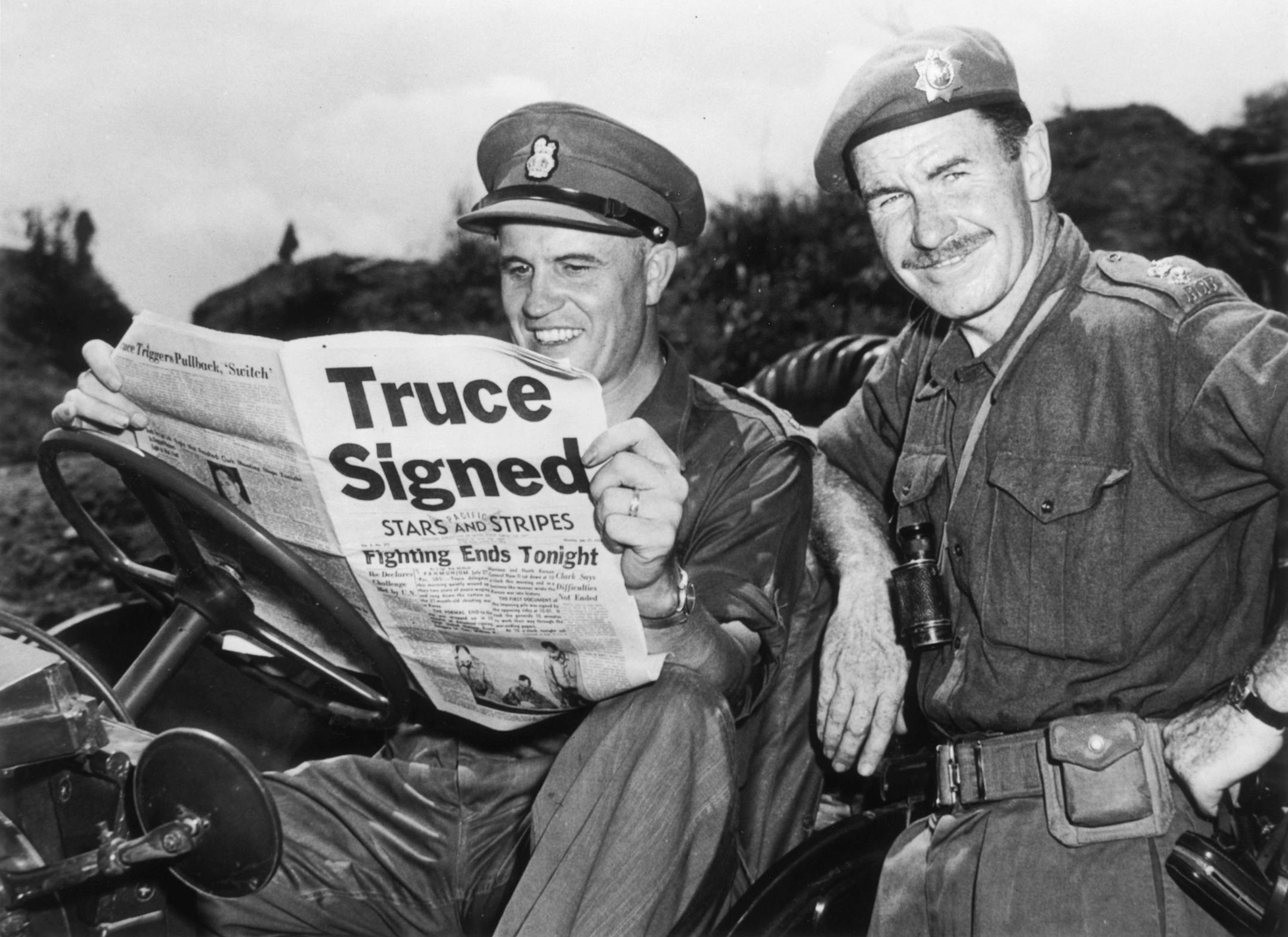 Brigadier Jean Allard, Commanding Officer of the Canadian Brigade, breaks the news of a truce in the Korean war to Colonel K L Campbell, Commander of the 3rd battalion of the RCRS, on Aug. 2, 1953 with an issue of Stars and Stripes. (Fox Photos/Getty Images/TNS)
