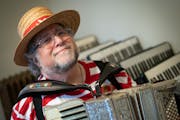 Mark Stillman plays an Excelsior accordion from the 1930's, Monday, Nov. 1, 2021, in his Minneapolis, Minn. home. This colorful musician dresses in co