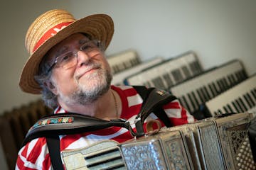 Mark Stillman plays an Excelsior accordion from the 1930's, Monday, Nov. 1, 2021, in his Minneapolis, Minn. home. This colorful musician dresses in co