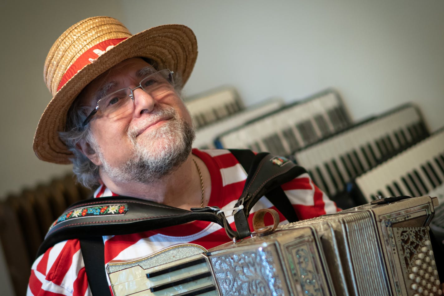 Mark Stillman plays an Excelsior accordion from the 1930's, Monday, Nov. 1, 2021, in his Minneapolis, Minn. home. This colorful musician dresses in costumes and plays music from around the world. He has more than 30 accordions at his home. ] GLEN STUBBE • glen.stubbe@startribune.com