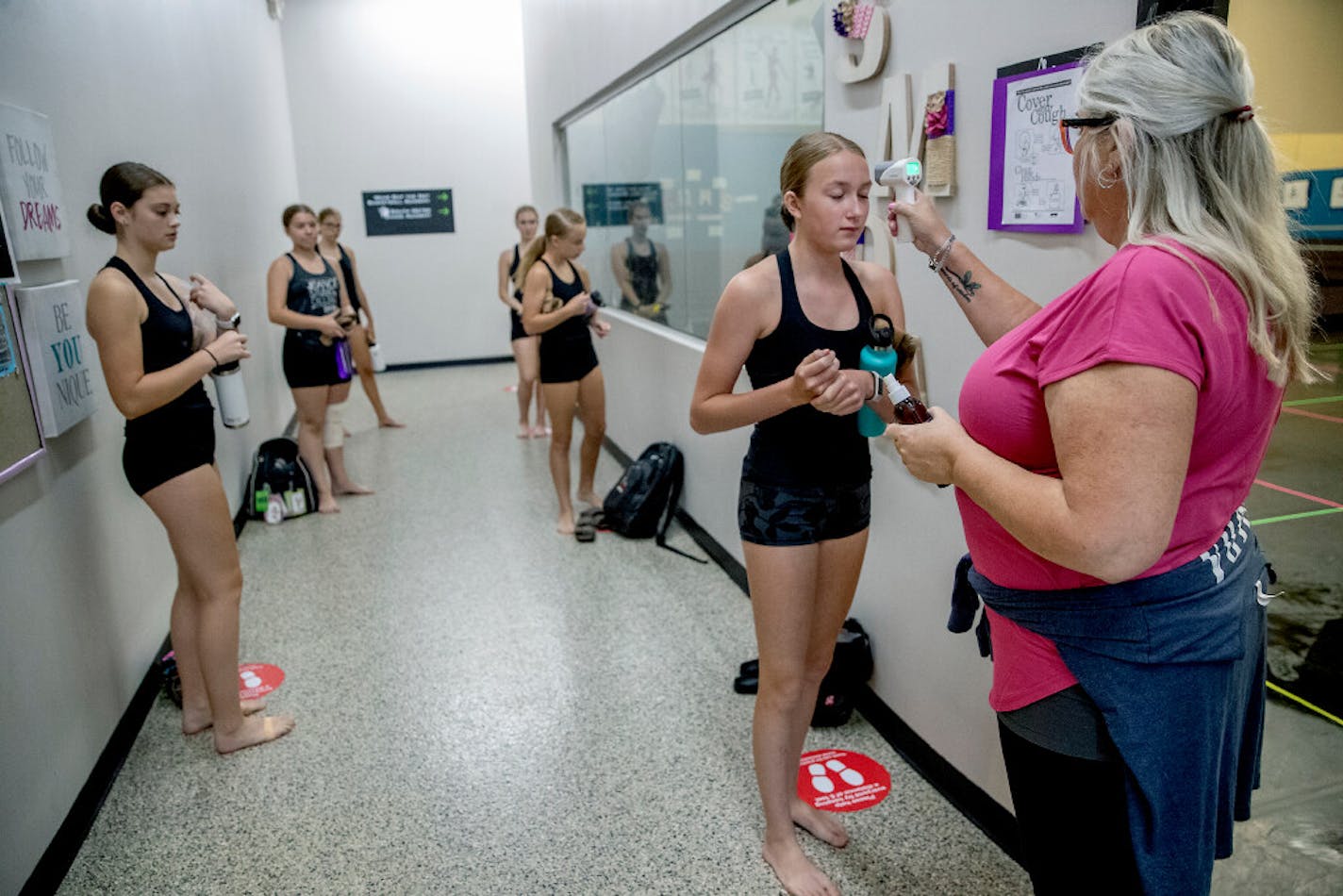 Jeanne Johnson took the temperatures of her dancers at South Metro Dance Academy before a class in Lakeville.