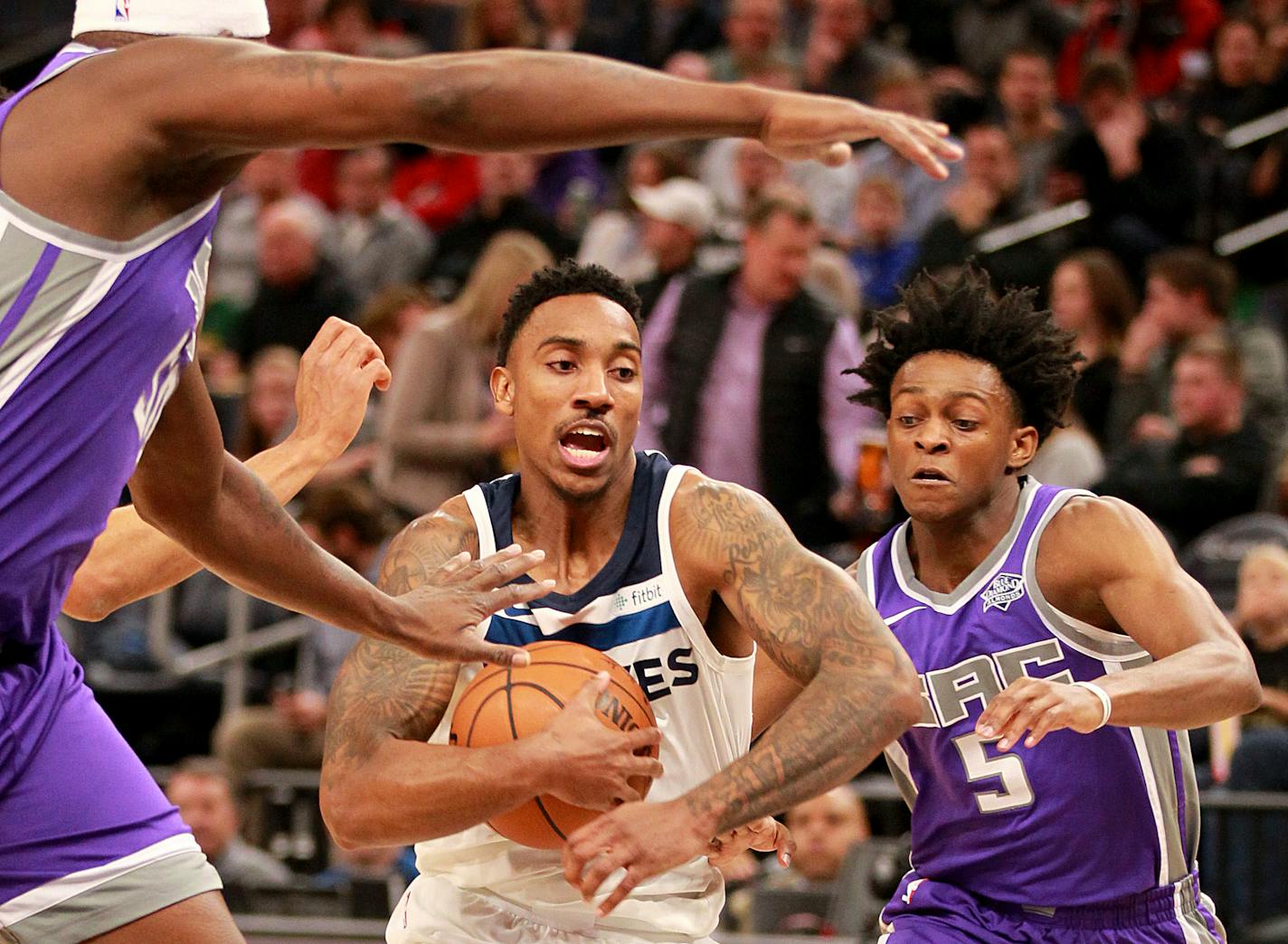 Minnesota Timberwolves guard Jeff Teague (0) drives on Sacramento Kings guard De'Aaron Fox (5) in the first quarter of an NBA basketball game on Thursday, Dec. 14, 2017, in Minneapolis. (AP Photo/Andy Clayton-King)