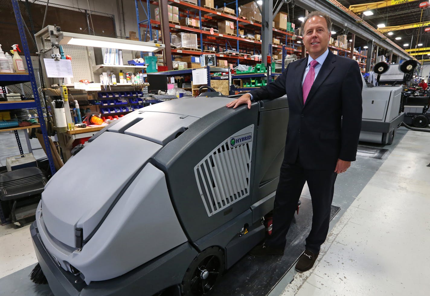 Nilfisk-Advance U.S. President Jeff Barna was photographed on 10/23/13 with an Advance CS7000 hybrid floor cleaner being built at the Plymouth MN factory. Danish company Nilfisk Advance, the low-profile competitor to Tennant in the floor-cleaning business for years, is bigger than Tennant and its U.S. operations, located just a few miles from Tennant's headquarters, has grown sales faster than the market or Tennant over the last 16 months under new leadership that arrived in 2012.] Bruce Bisping