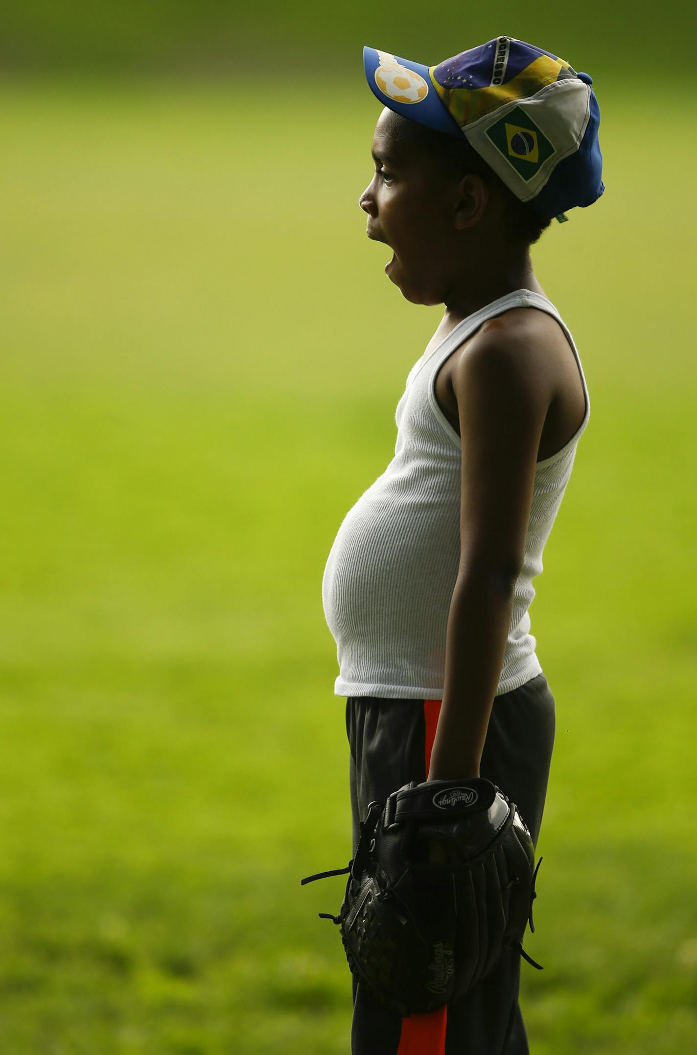 Carlos Ladron de Guevara, 9, yawned while his partner chased down a ball during practice last month at Bryant Square Park. ] JEFF WHEELER &#x201a;&#xc4;&#xa2; jeff.wheeler@startribune.com Bryant Square Park rec center little league team had a practice on their home field Tuesday night, June 17, 2014.